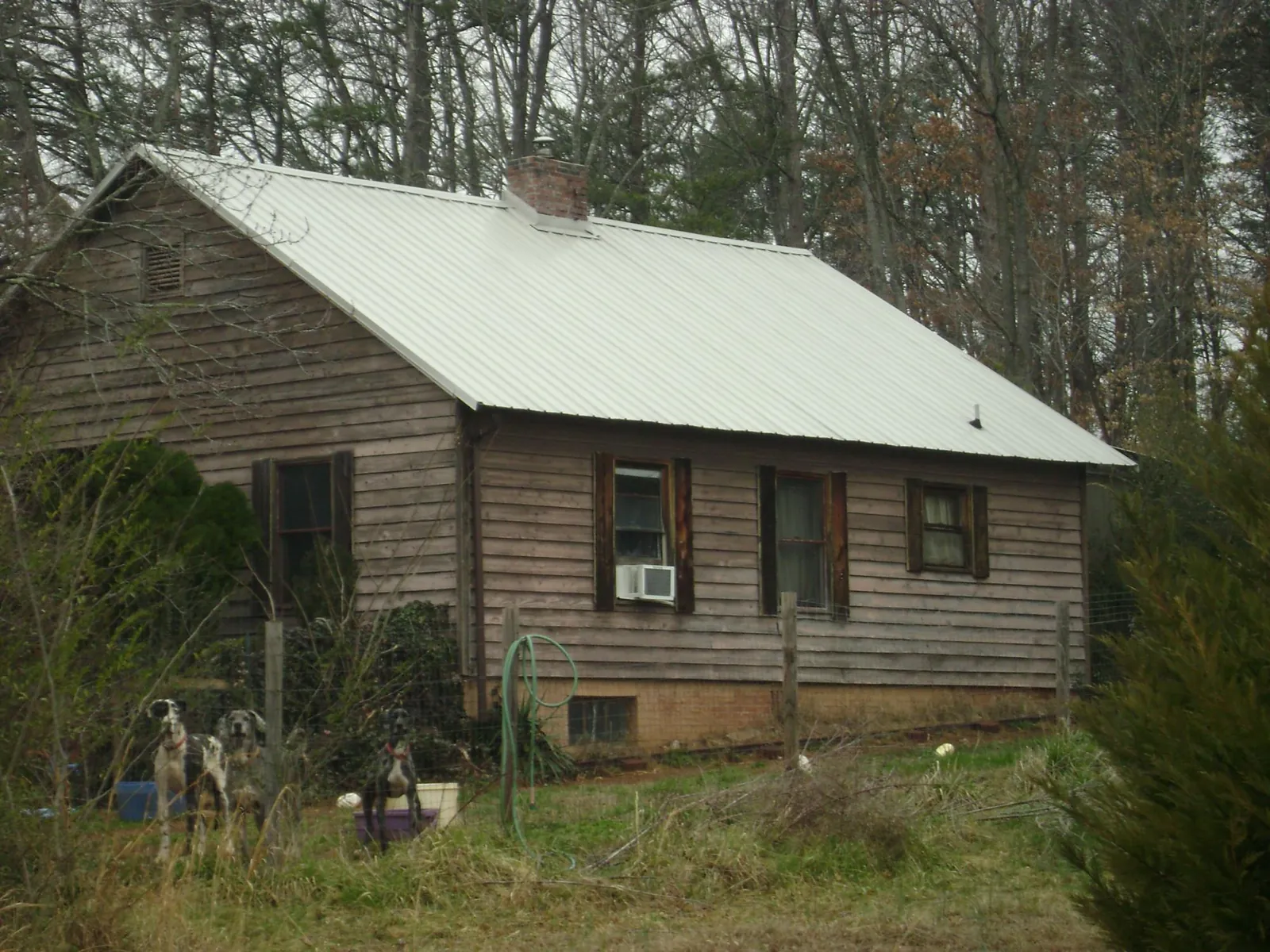 White metal roof on an old wood sided farmhouse, from a Metal Roof Installation job in Rickman