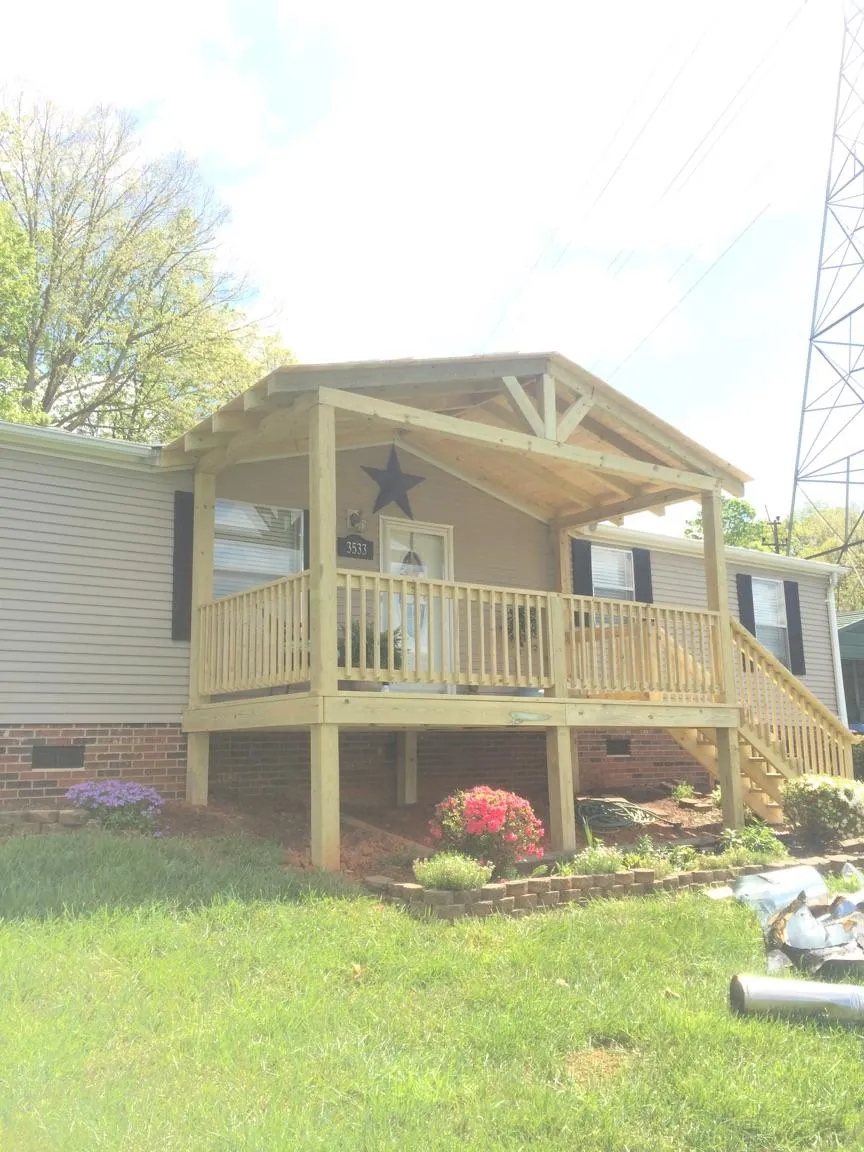 New gabled porch roof and deck railing added to a ranch home in Rickman